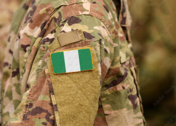 Nigeria flag on soldiers arm. Federal Republic of Nigeria troops (collage)