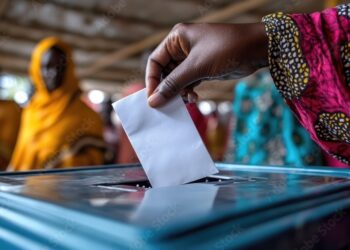 Woman dropping ballot at polling station during election day